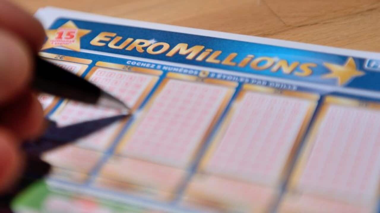 A person fills an Euro Millions lottery ticket