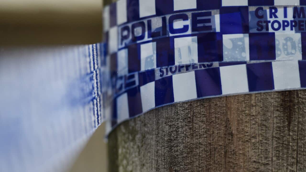 Police tape is seen at a home