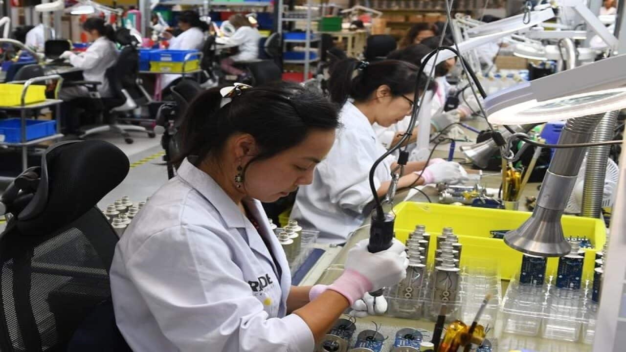 A photo of workers at the Rode microphone factory.