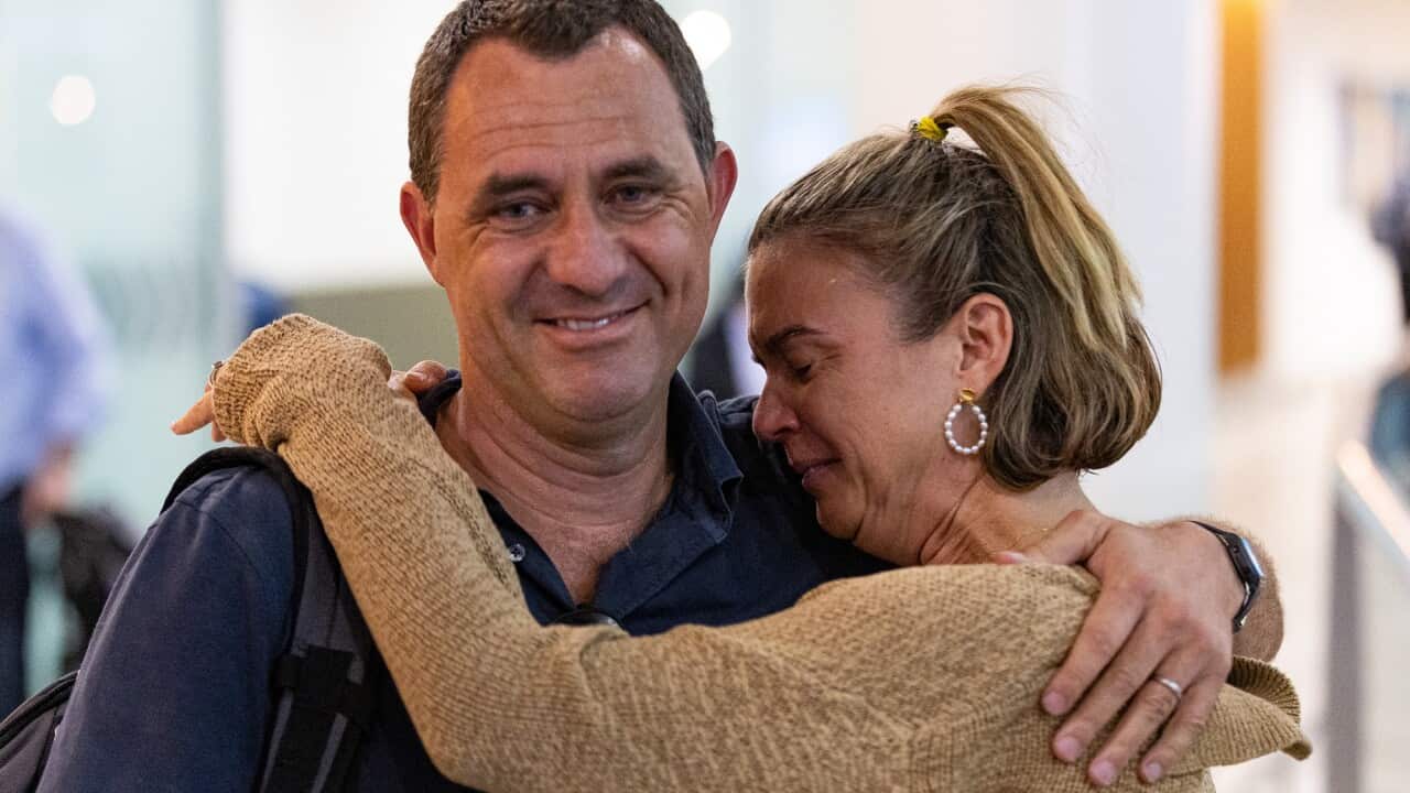 Chris Salmon hugs his wife.