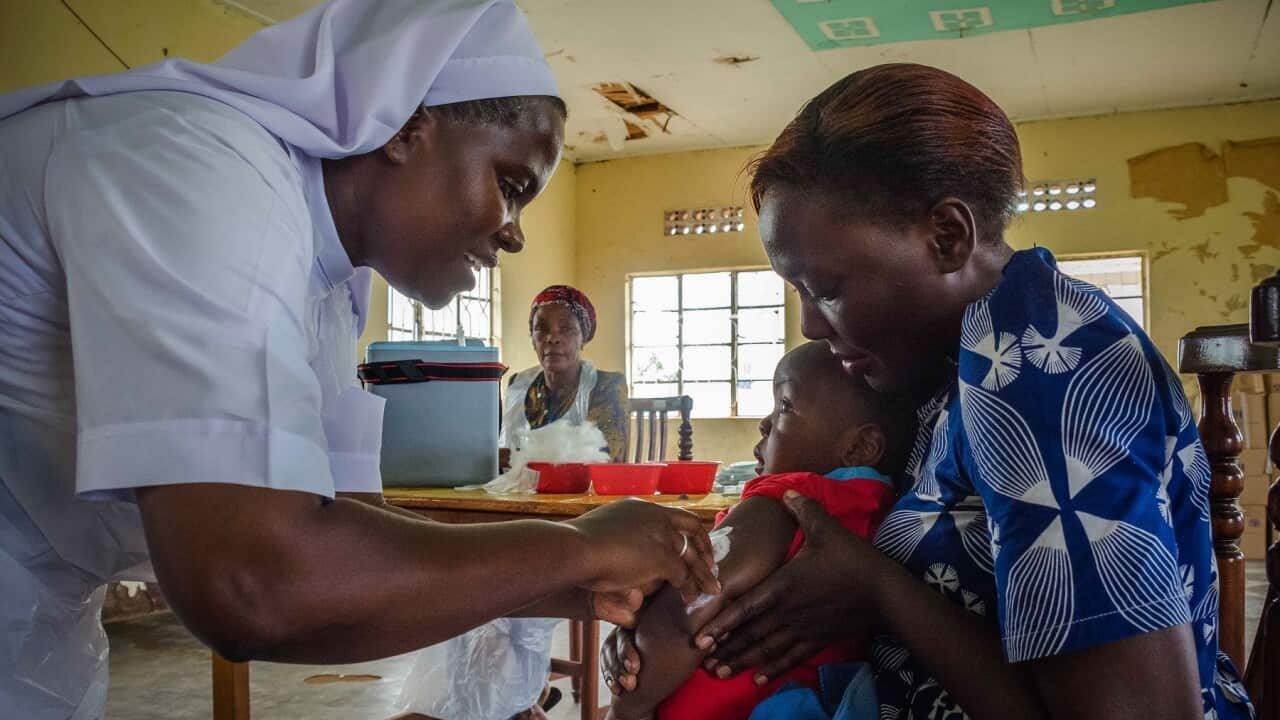 A child reacts as he receives an injection during the nationwide vaccination campaign against measles, rubella and polio.