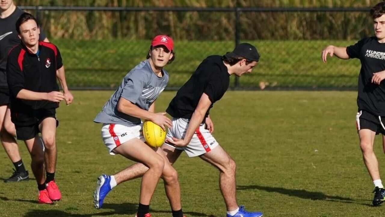 People playing football in a park