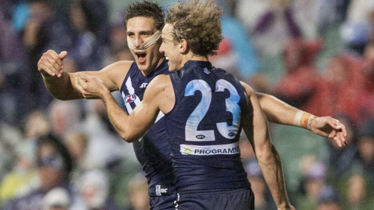 Matthew Pavlich celebrates a goal with Chris Mayne