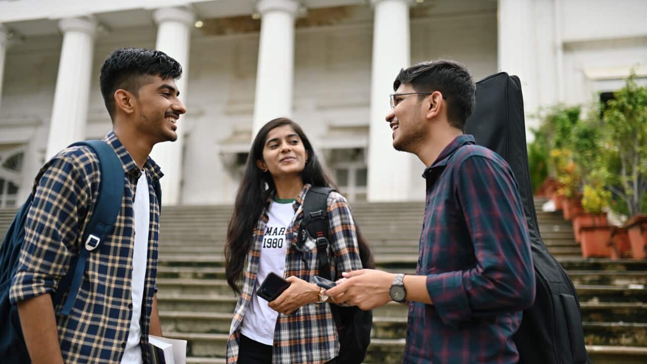 University Student friends standing and talking in the University campus