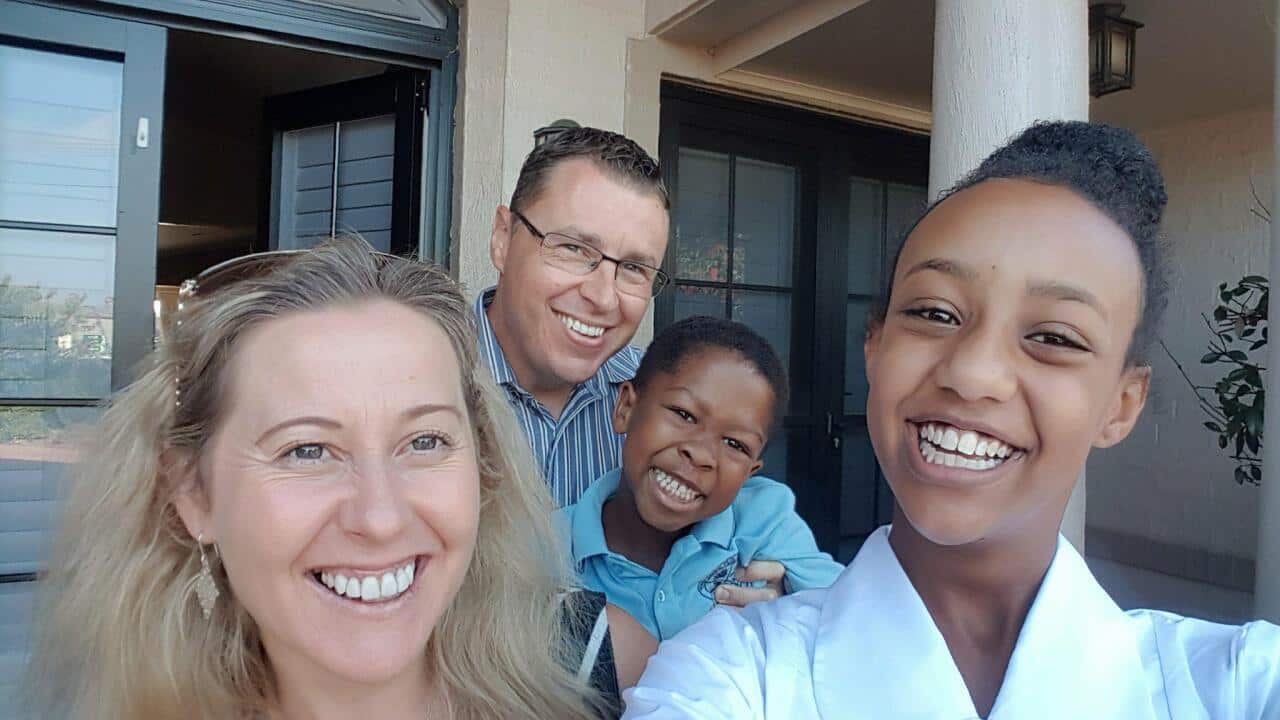 photograph of Tsehay Hawkins' intercultural family in front of house