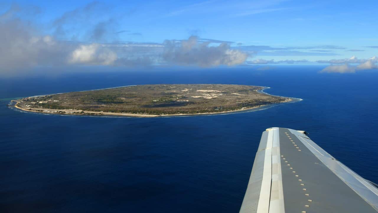 Nauru island from the air, with Boeing 737 starboard wing - South Pacific Ocean