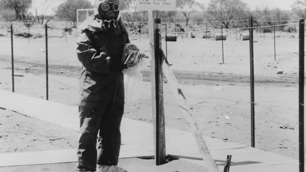 A 1950 file photo of John L Stanier in the South Australian town of Maralinga wearing protective clothing. (AAP Image/National Archives of Australia)