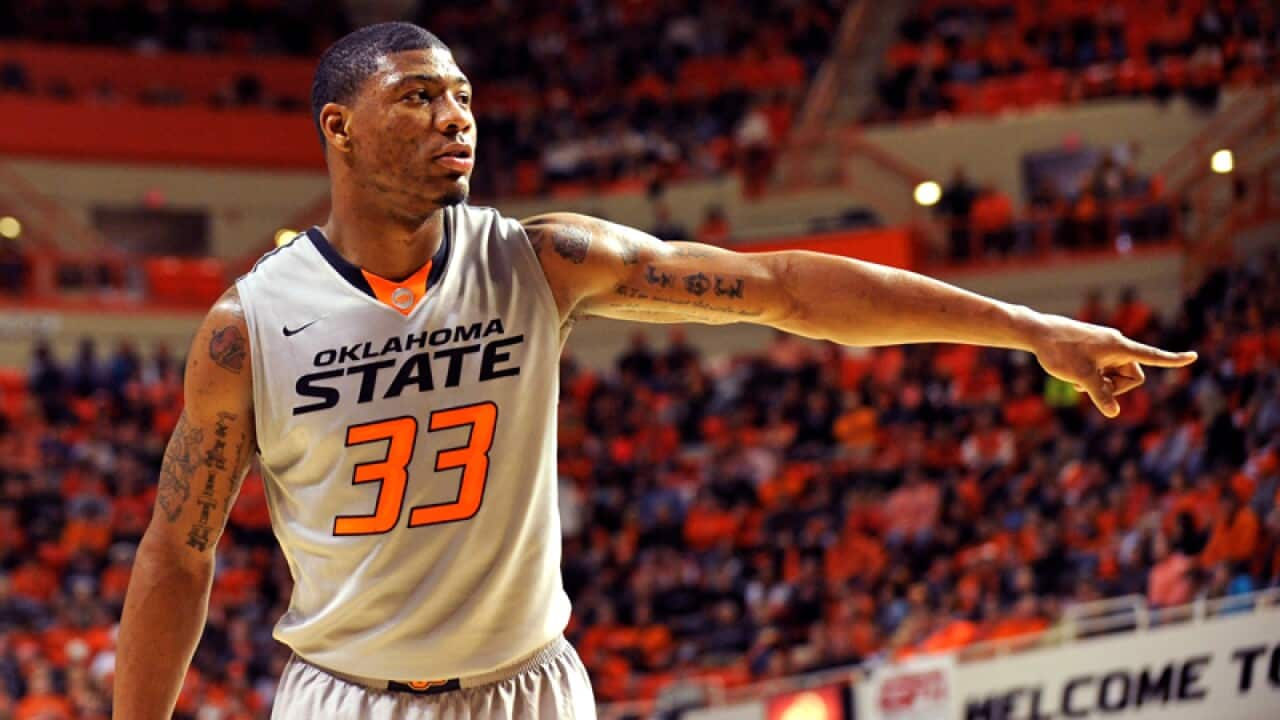 Marcus Smart gestures as he plays for Oklahoma State