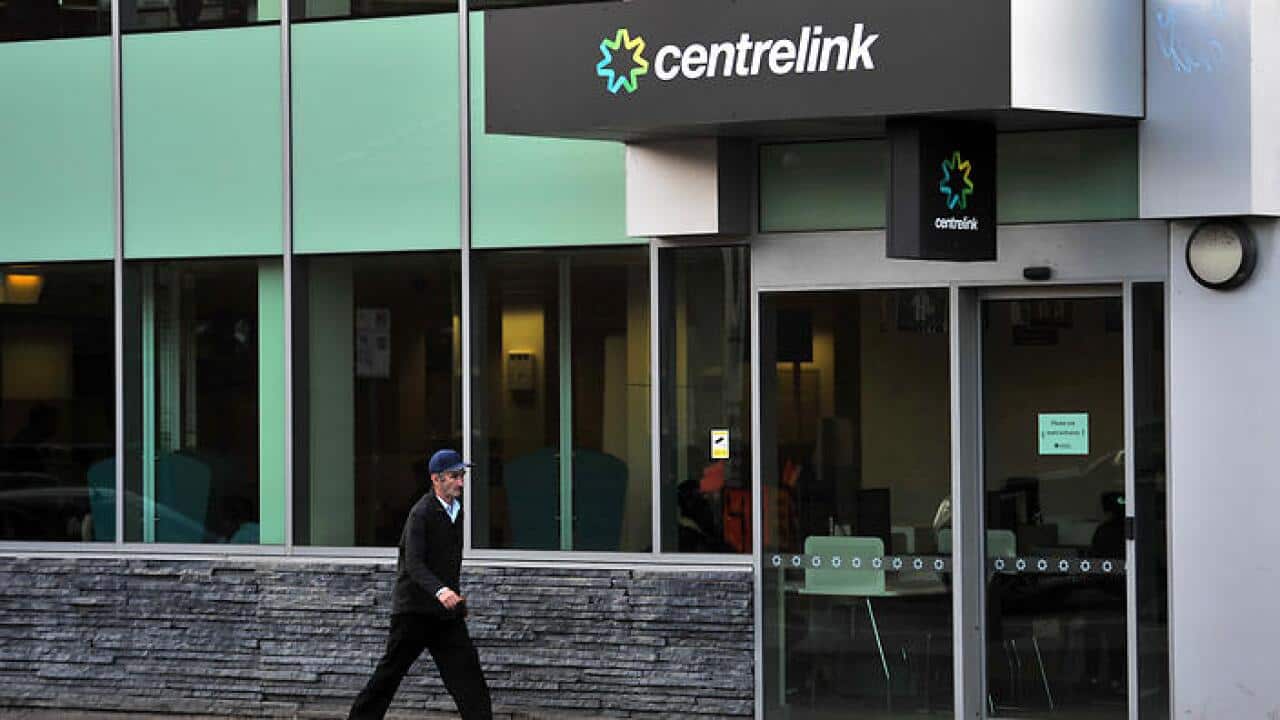 A man walks past a Centrelink branch in Melbourne, Wednesday, May 14, 2014. The federal budget has propsoed sweeping changes to Centrelink payments including Newstart unemployment support and the aged pension. (AAP Image/Julian Smith) NO ARCHIVING