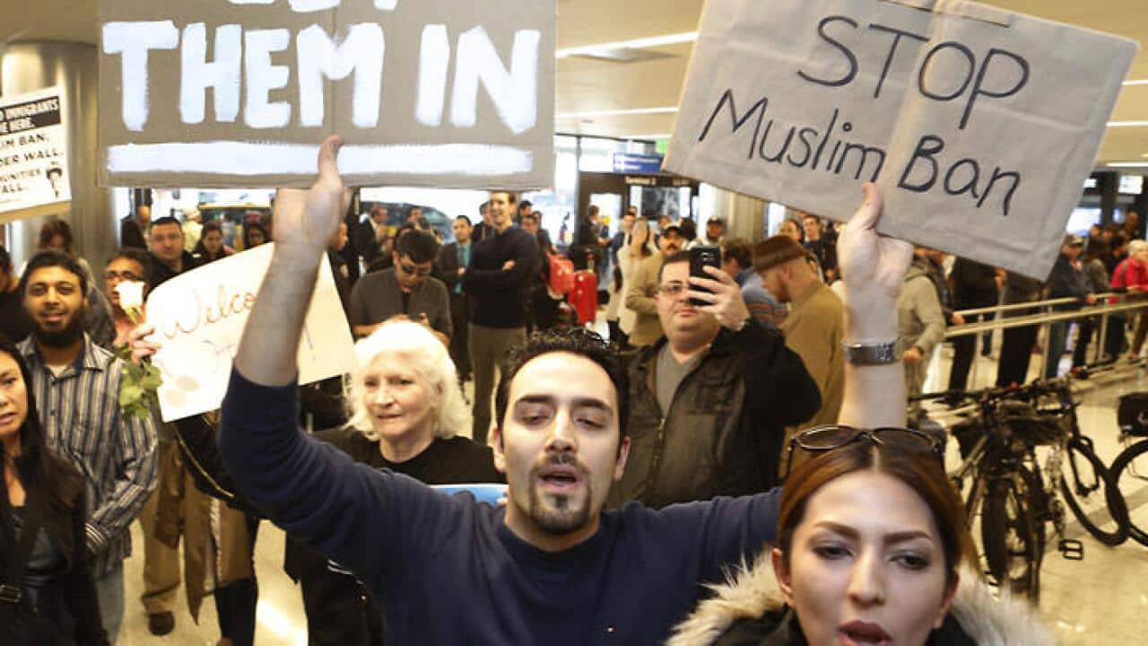 Supporters cheer as an Iranian citizen with a valid U.S. visa arrives at Los Angeles International Airport