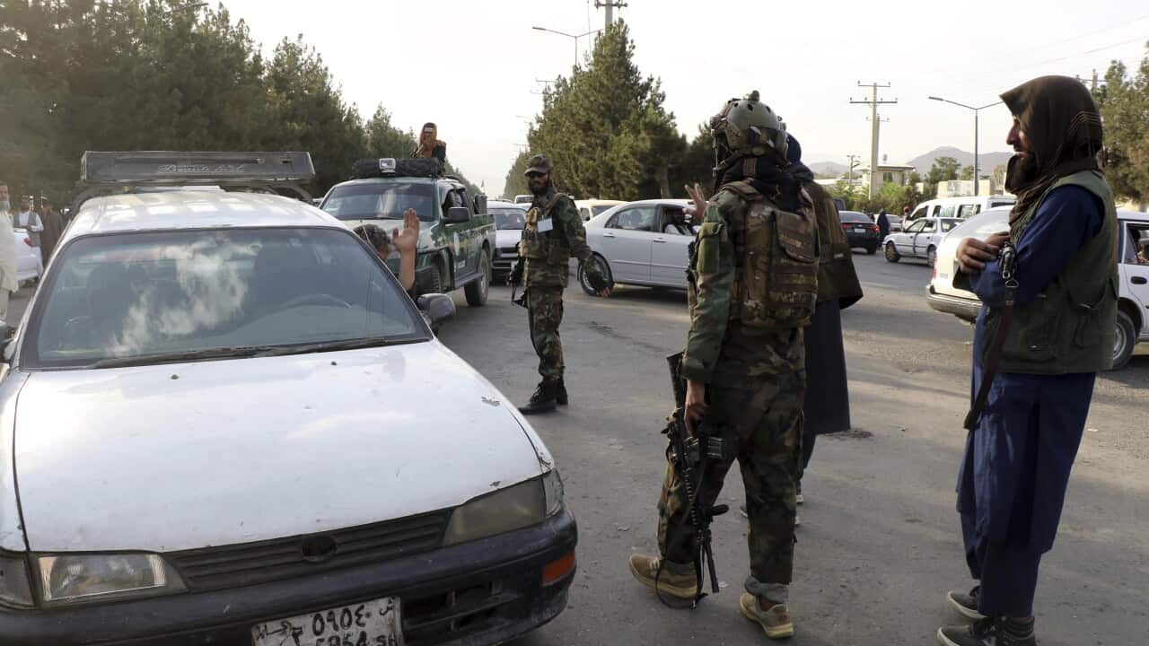 Taliban fighters stand guard at a checkpoint near the gate of Hamid Karzai international Airport in Kabul, Afghanistan, Saturday, August 28, 2021.