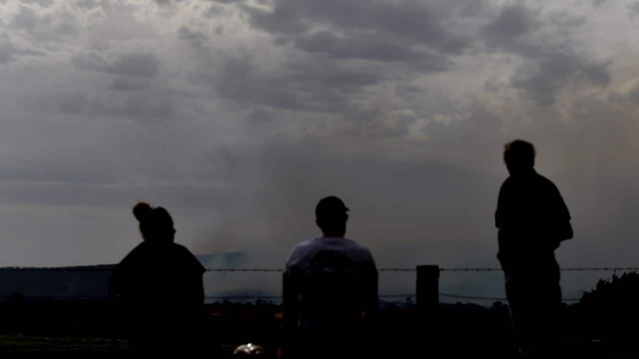 Locals watch the view of the Lancefield fire in Victoria