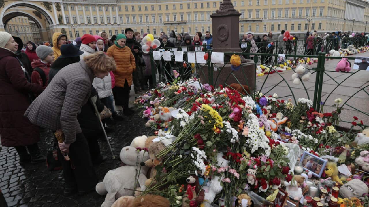People lay flowers in memory of the Russian plane crash victims