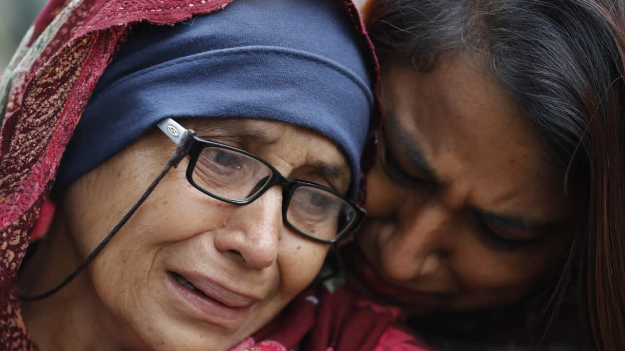 A women who lost her husband during cries outside a information center for family in Christchurch, New Zealand.