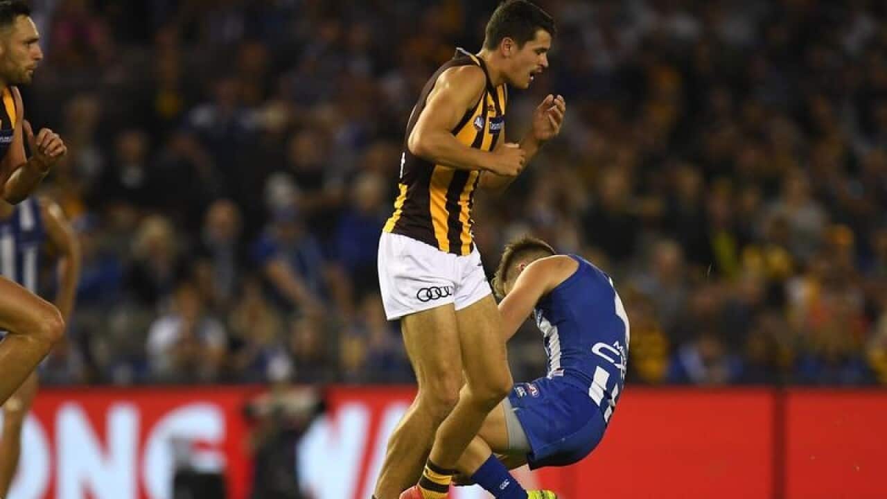 Shaun Higgins of the Kangaroos knocked out.