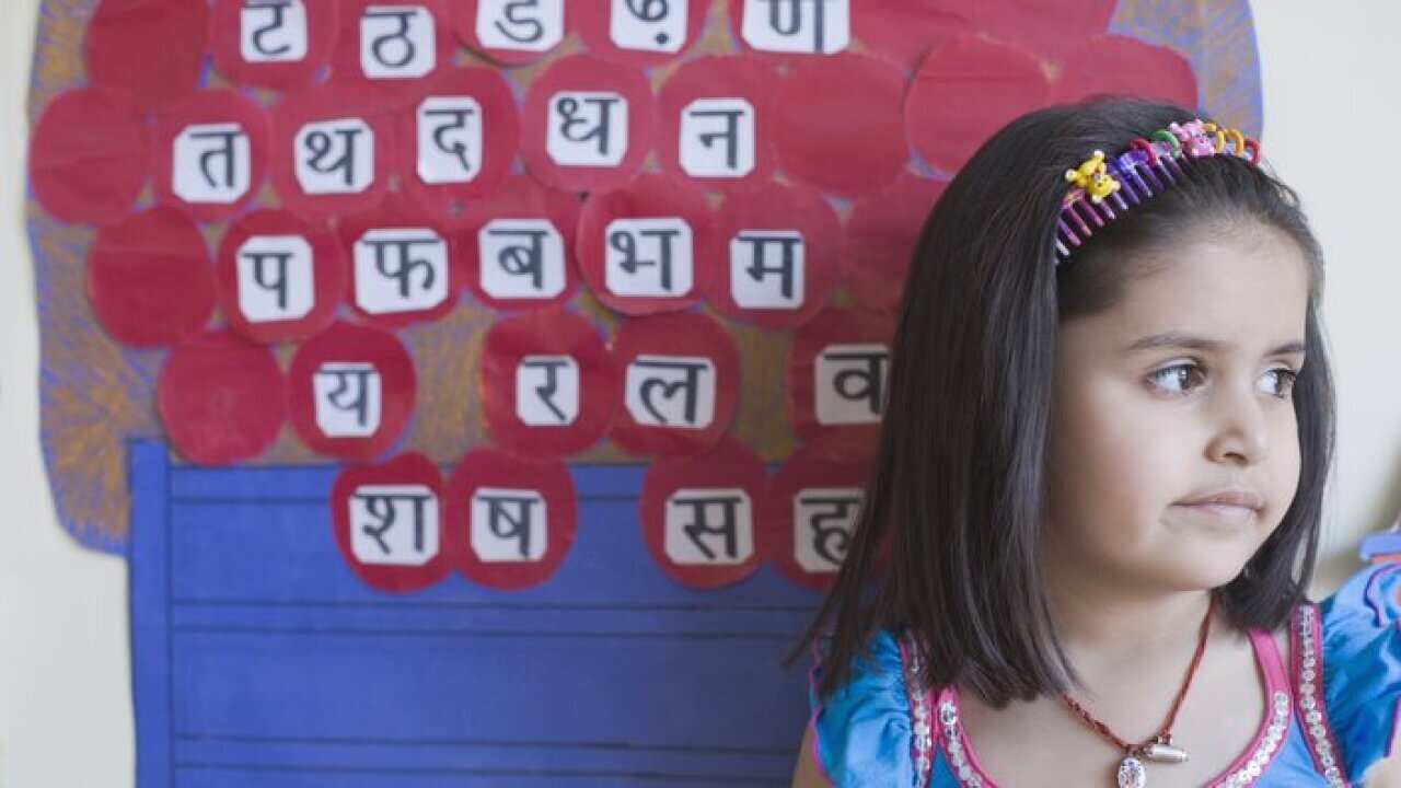 Close-up of a schoolgirl in front of a chart