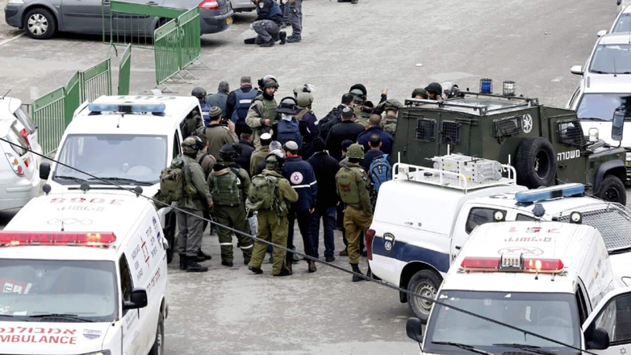 Israeli security forces stand guard at a scene of shooting