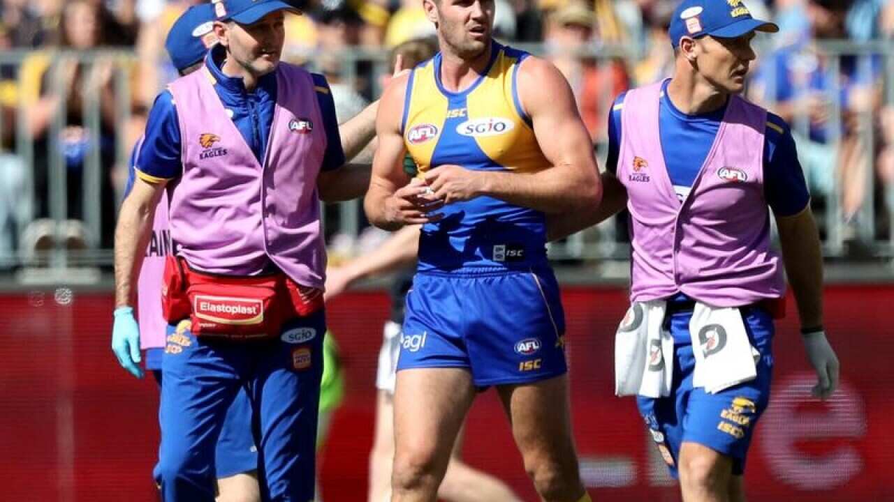 Jack Darling of the Eagles (C) leaves the field with an injury