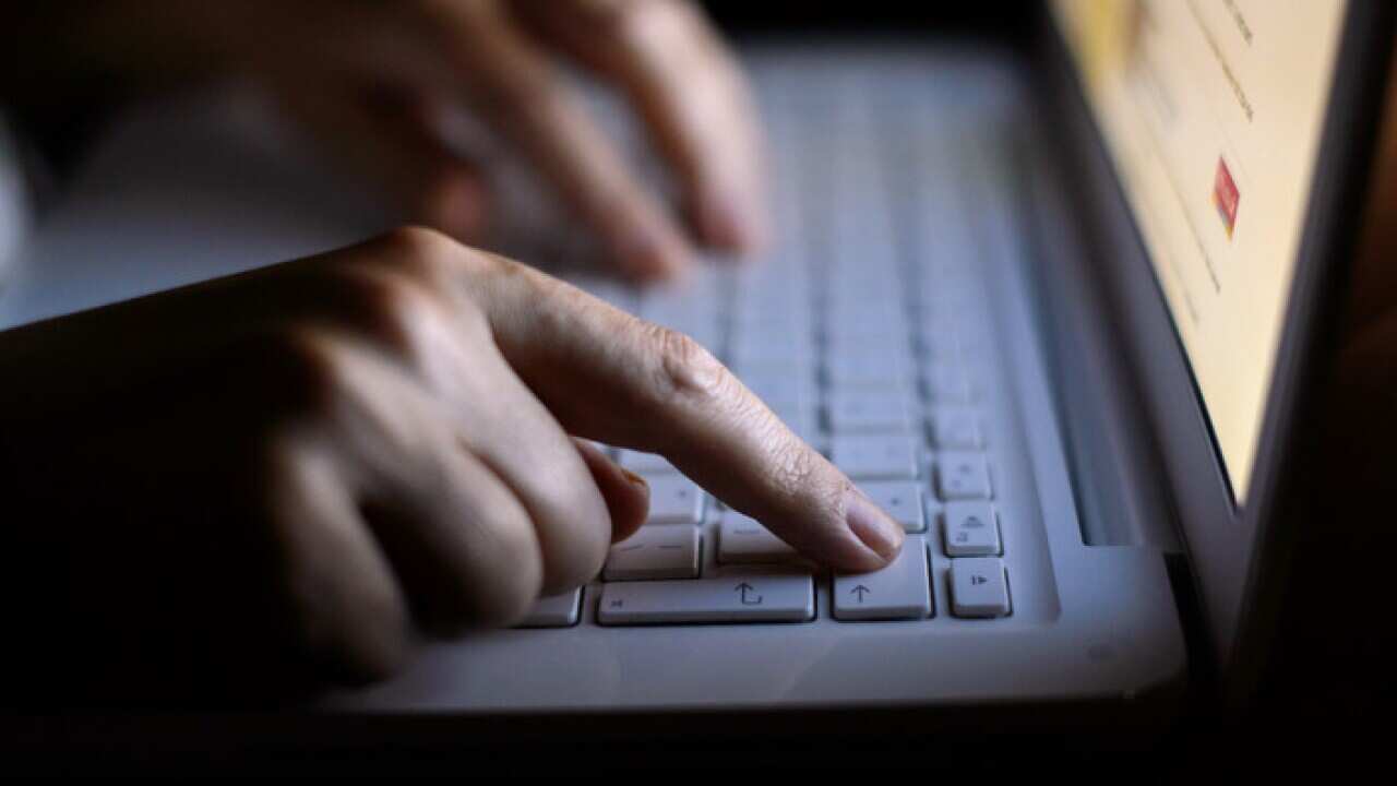 Generic stock photo shows a woman's hands using a laptop keyboard.