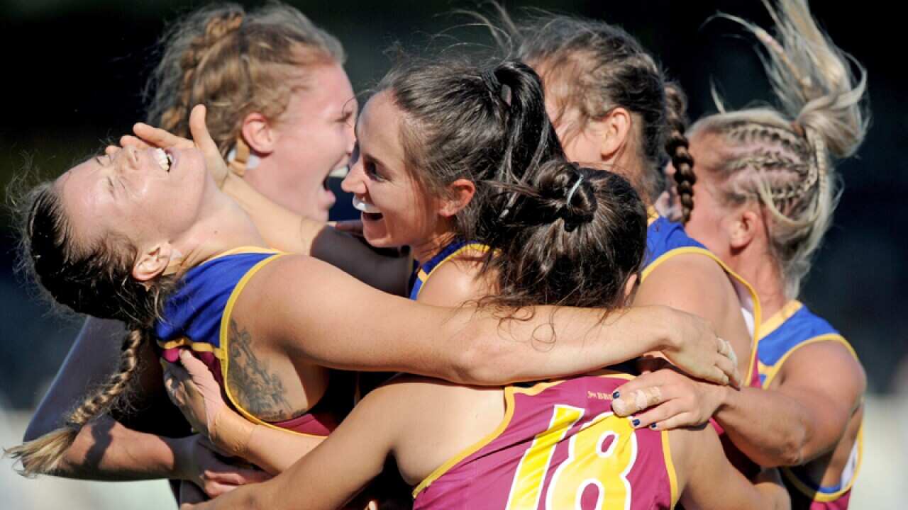Brittany Gibson of the Lions (far left) celebrates with team-mates