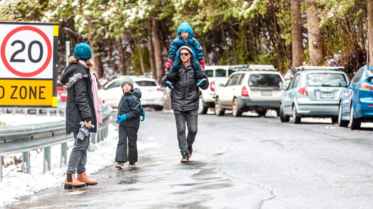 People are seen at Mt Wellington, in Hobart, Tuesday, July 19, 2022. Southeast Australia is in for more chilly temperatures this week, as a high-pressure system strengthens and Tasmania is hit with snow in low-lying areas. (AAP Image/Josh Agnew) NO ARCHIVING