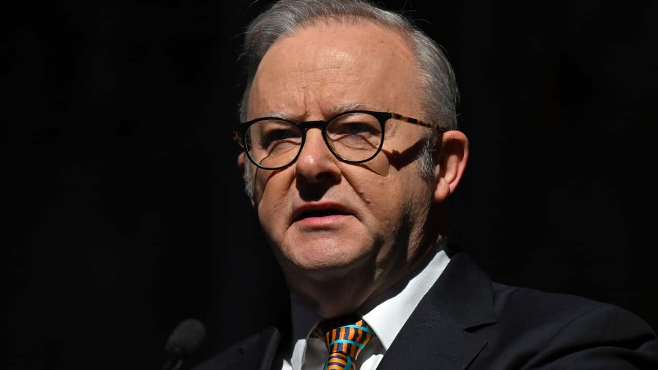 A middle-aged white man with short grey hair and wearing glasses and a tie
