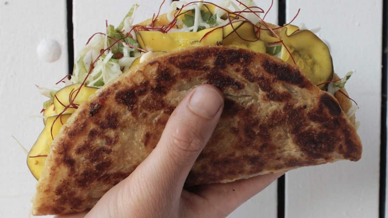 paratha filled with vegetables in a hand