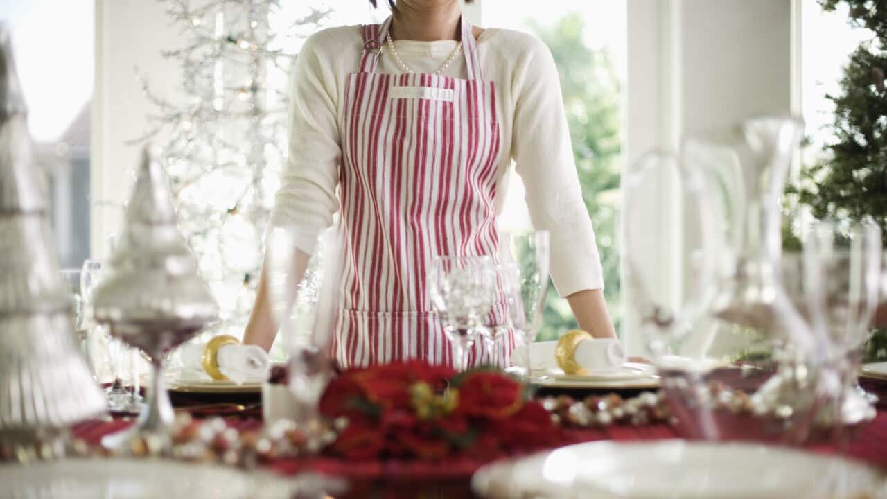 Woman Standing by Table Decorated for Christmas