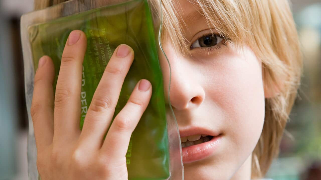 Boy with ice pack on his eye