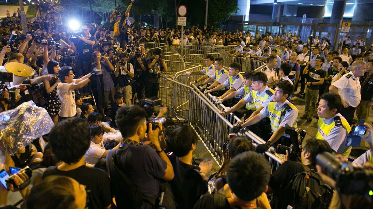 Protesters confront police outside the legislative government complex on October 2, 2014 in Hong Kong, calling for open elections and the resignation of Hong Kong's Chief Executive Leung Chun-ying. (Paula Bronstein/Getty)