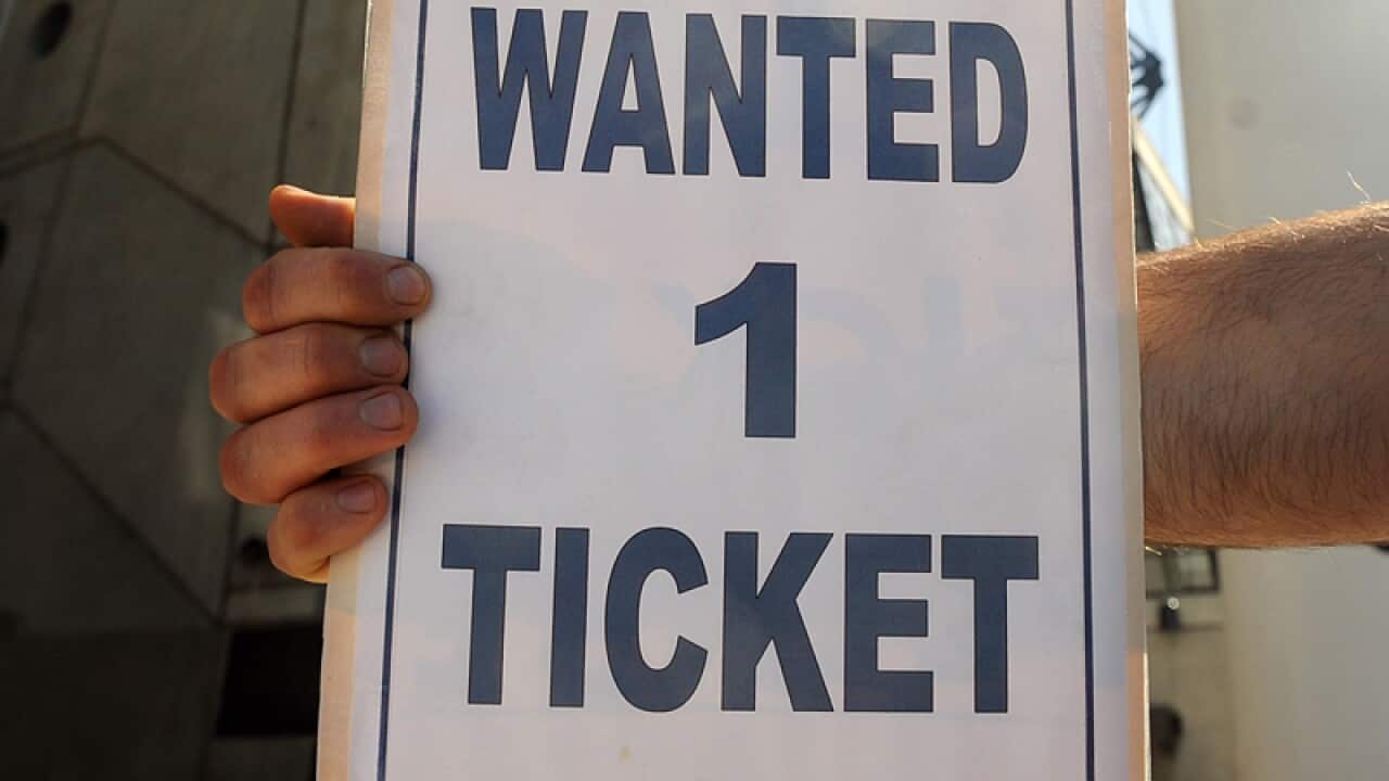 An AFL fan looks for a ticket ahead of the Grand Final