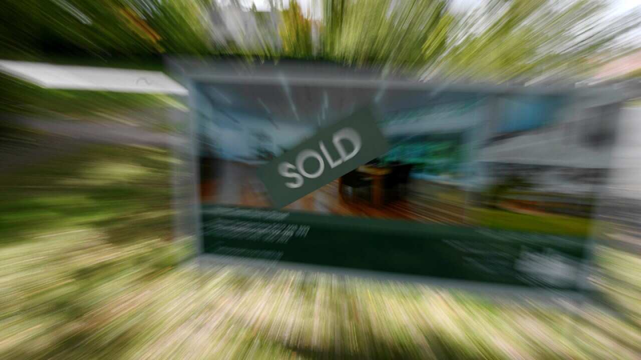 A real estate advertising board with a Sold sign