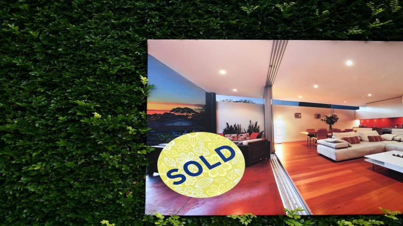 A for sale sign displayed in front of a house