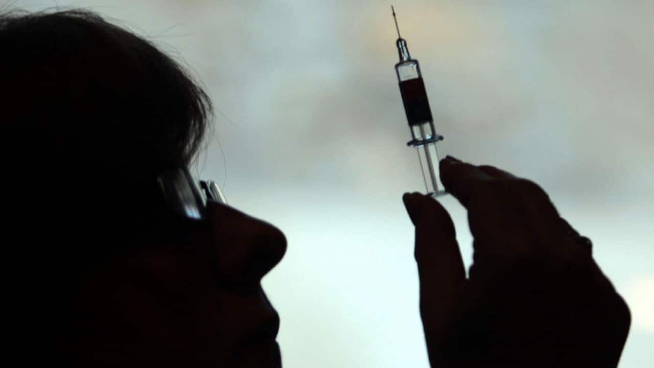 A nurse preparing to give a patient an HPV vaccine to protect against cervical cancer