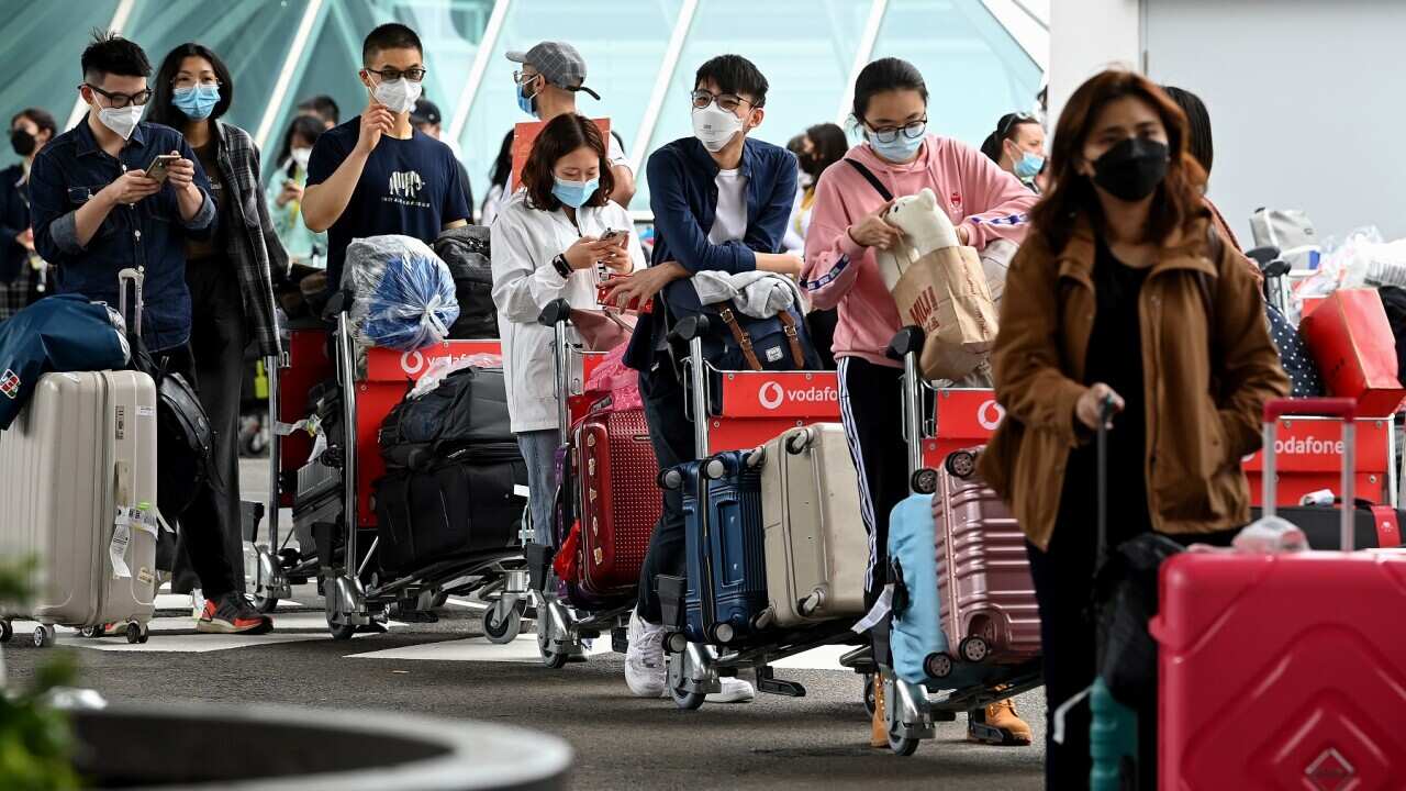 International students wear face masks as they arrive at Sydney Airport in Sydney