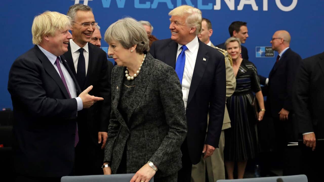 Donald Trump jokes with Boris Johnson as Theresa May walks past them during a NATO summit in 2017.