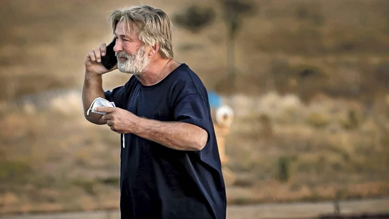 Alec Baldwin speaks on the phone outside the Santa Fe County Sheriff's Office, after he was questioned about a shooting on the set of the film Rust.