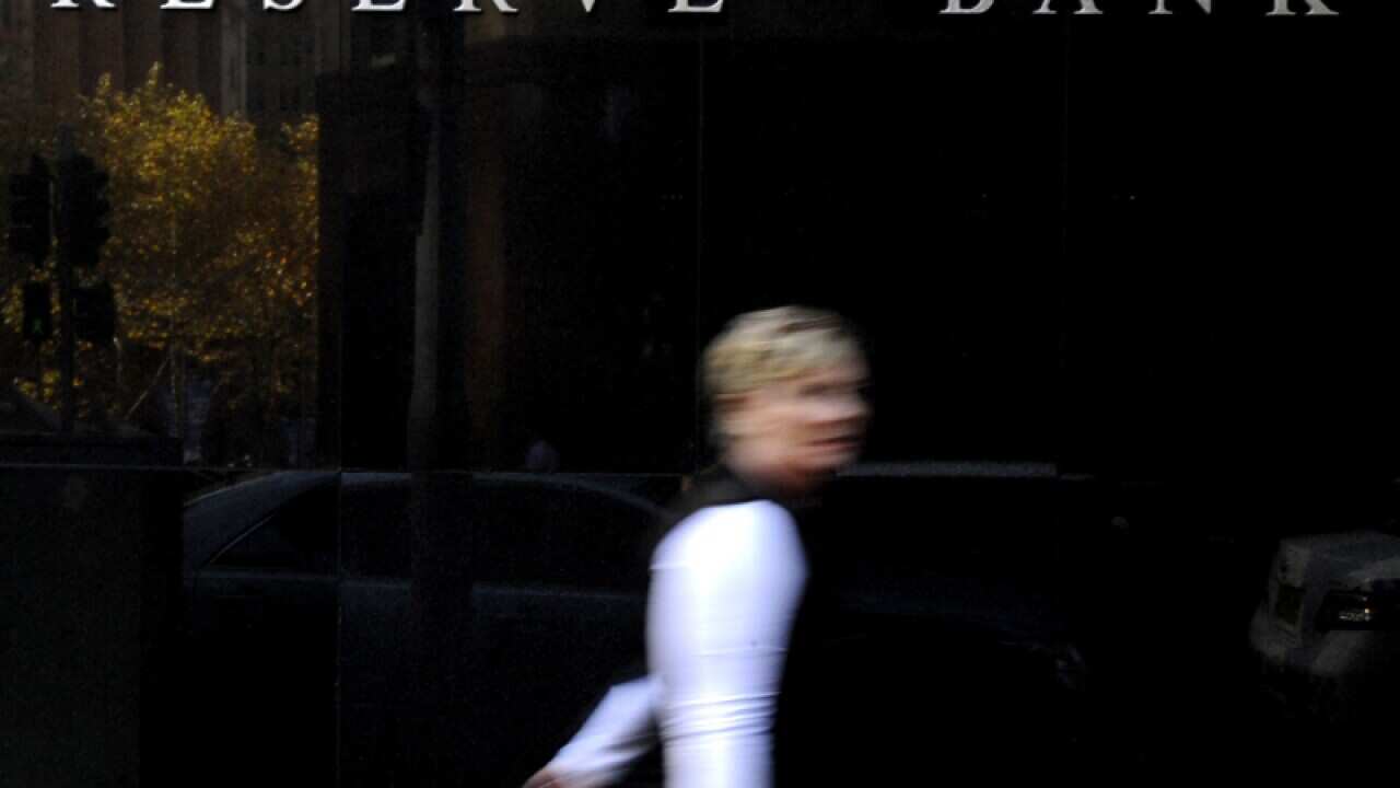 A pedestrian walks past the Reserve Bank of Australia