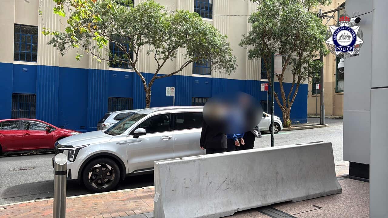 A blurred person getting arrested.