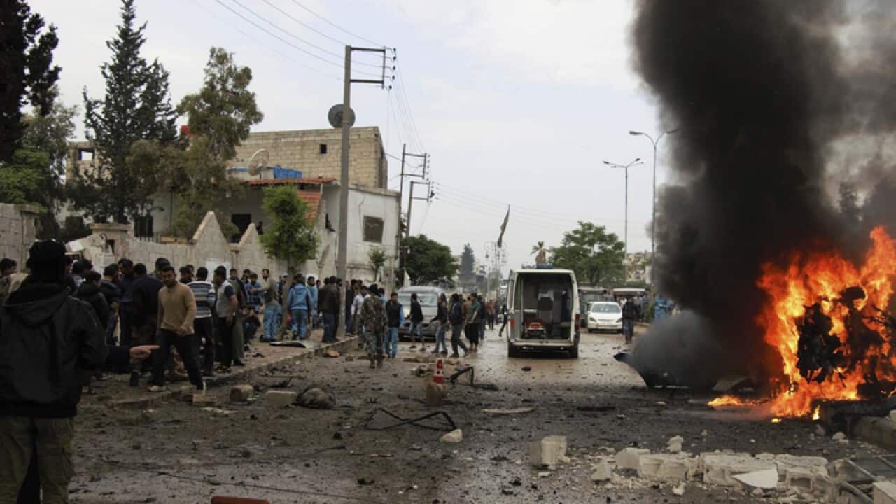 A burning car at the explosion scene, in Azaz town