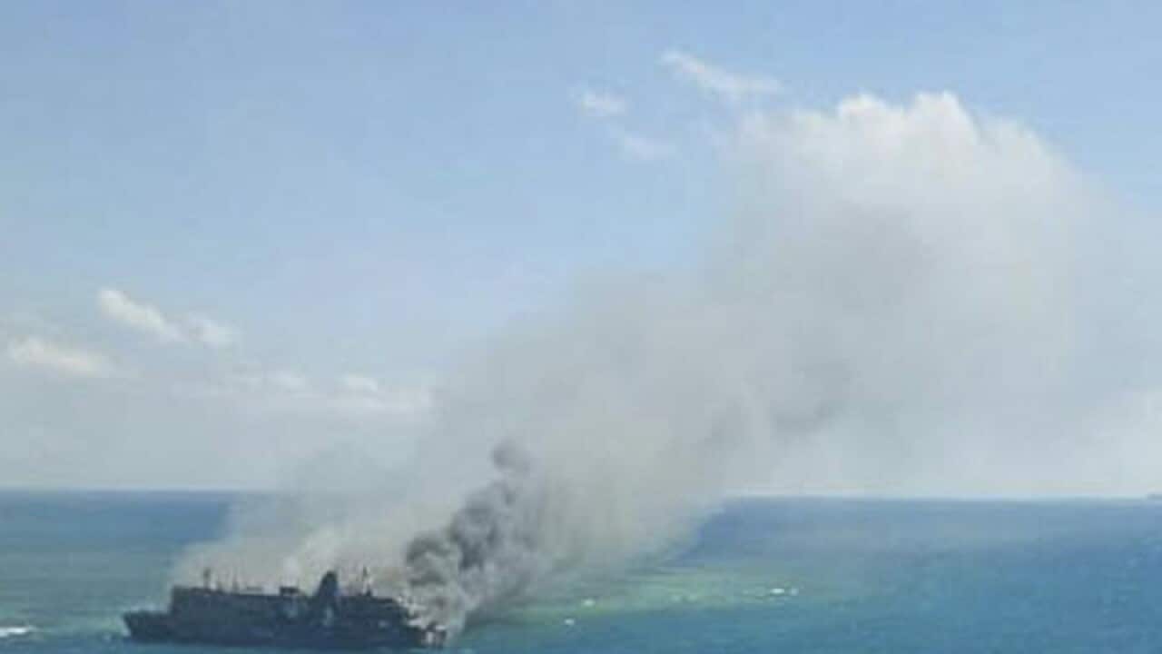 Smoke rises from a burning ferry in waters off East Java