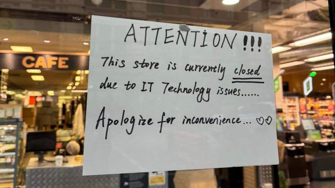 A sign outside a supermarket that reads ATTENTION