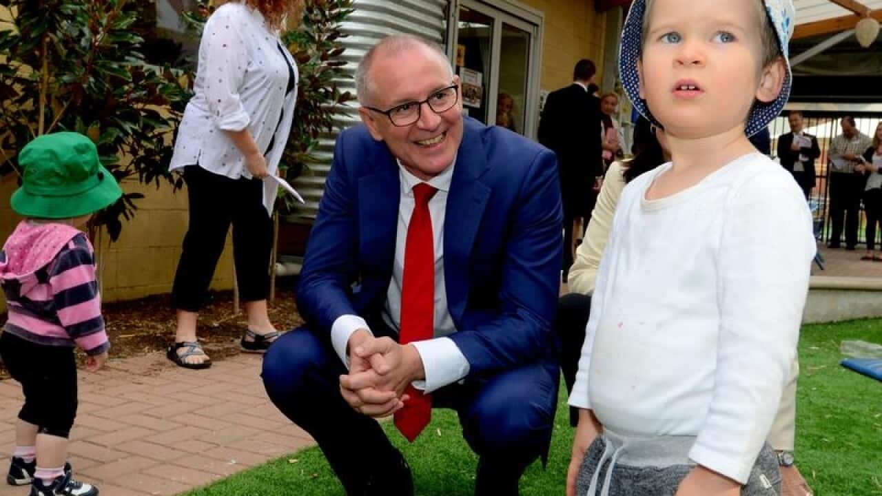 SA Premier Jay Weatherill is seen with a child