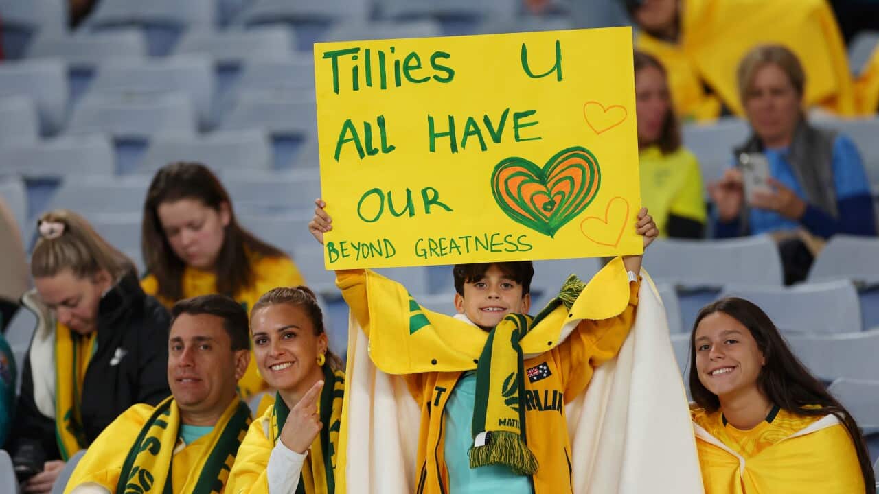 Matildas fans at Stadium Australia ahead of the match hold up a sign that reads "Tillies you all have our hearts."