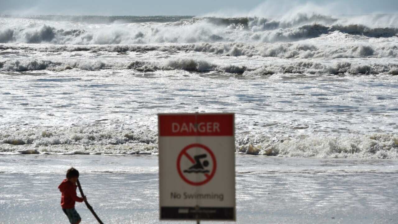 A sign informing the beach is closed at Burleigh Heads on the Gold Coast, Sunday, June 5, 2016.