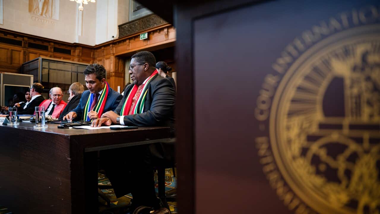 South Africa's legal team sits behind a desk inside the court.