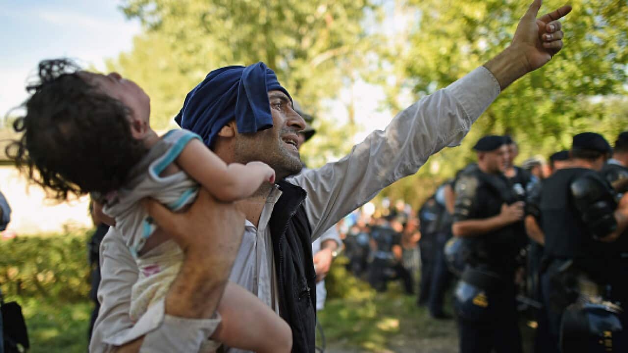 Migrants force their way through police lines at Tovarnik station to board a train bound for Zagreb on September 17, 2015 in Tovarnik, Croatia. Migrants are now diverting to Croatia from Serbia after Hungary closed its border with Serbia (Getty)