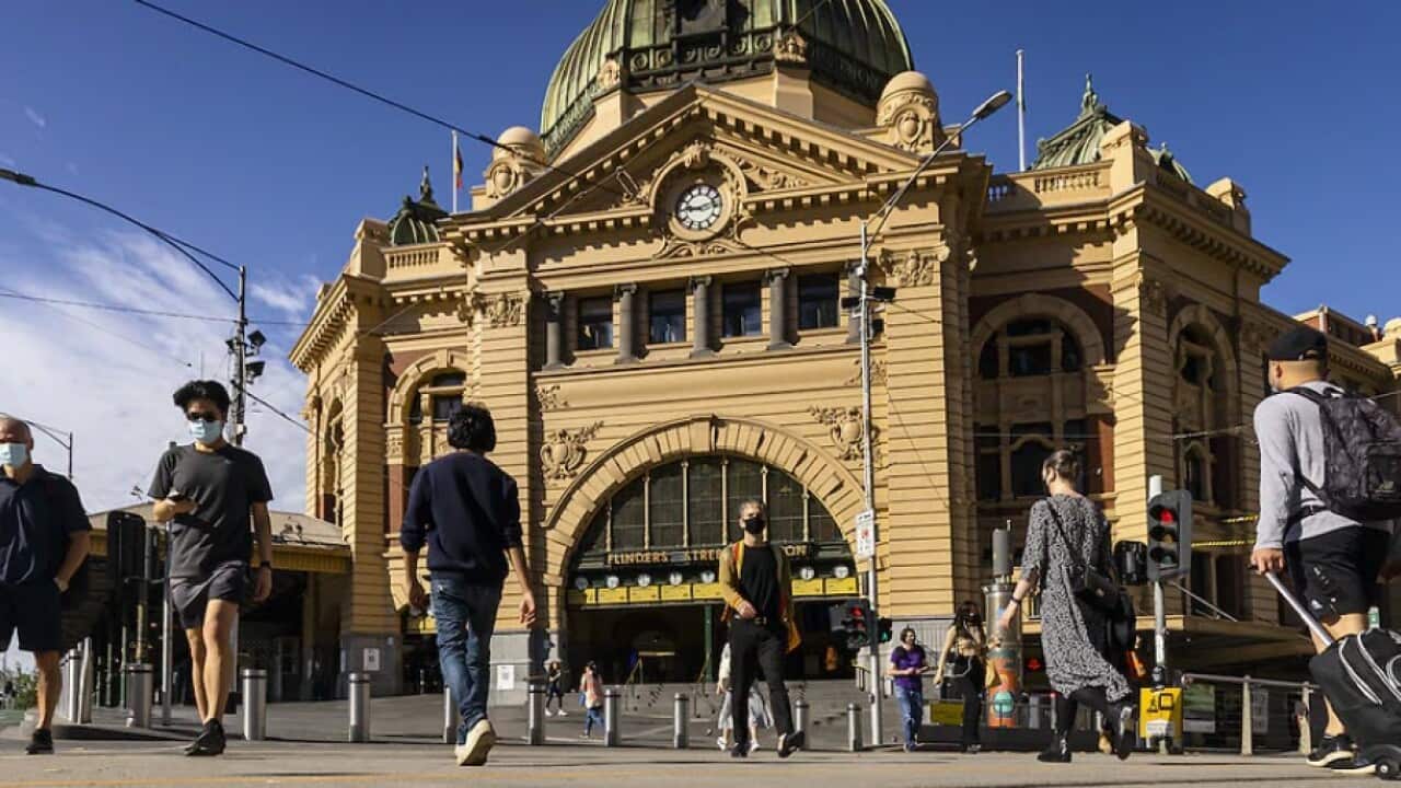 People walking across Flinders street station in Melbourne