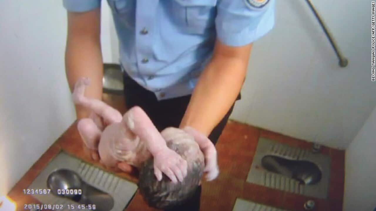 A still taken from an amateur video shows the newborn's rescue
