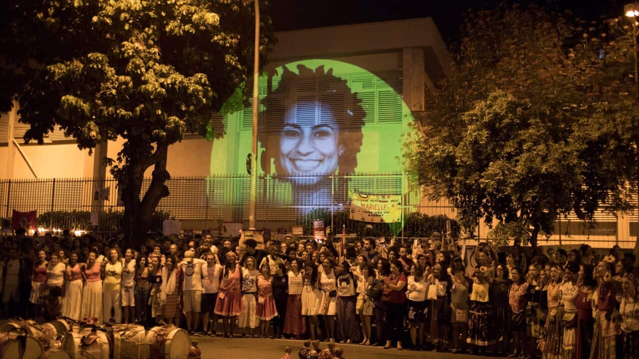 Protesters gathering around image of Marielle Franco